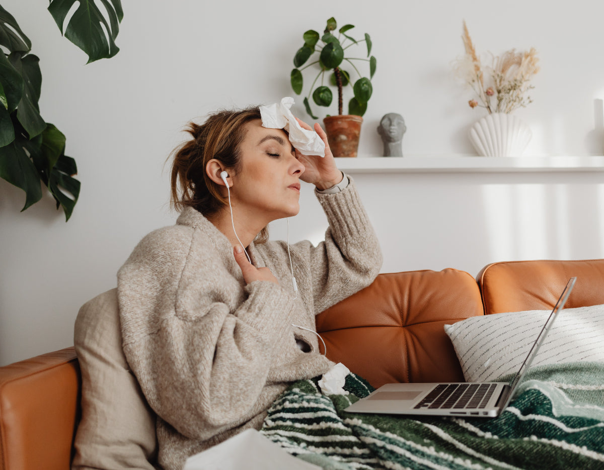 Woman having a hot flash at her laptop